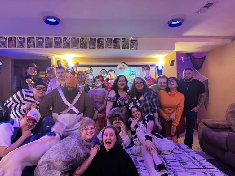 A group photo from last year's Halloween party, showing everyone in costume.